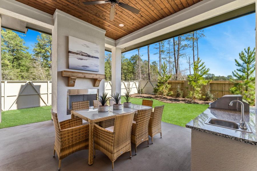 Covered "Outdoor Living" with fireplace and kitchen Covered "Outdoor Living" with fireplace and kitchen