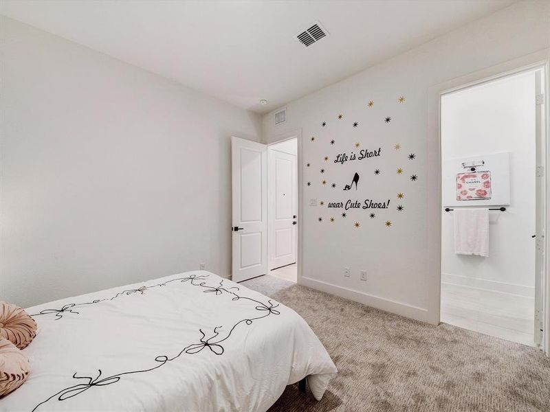 Bedroom featuring light carpet and connected bathroom Bedroom featuring light carpet and connected bathroom