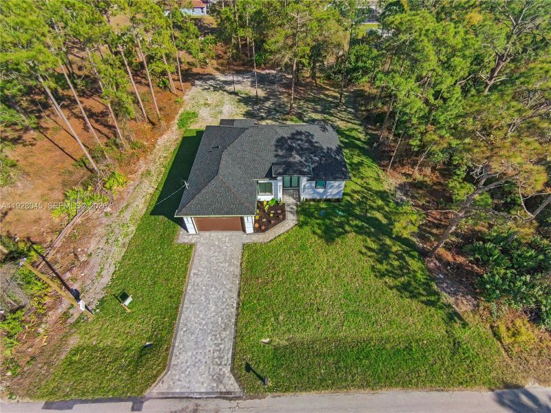 Front exterior of a new home in , Lehigh Acres, FL, highlighting curb appeal (Image 28).