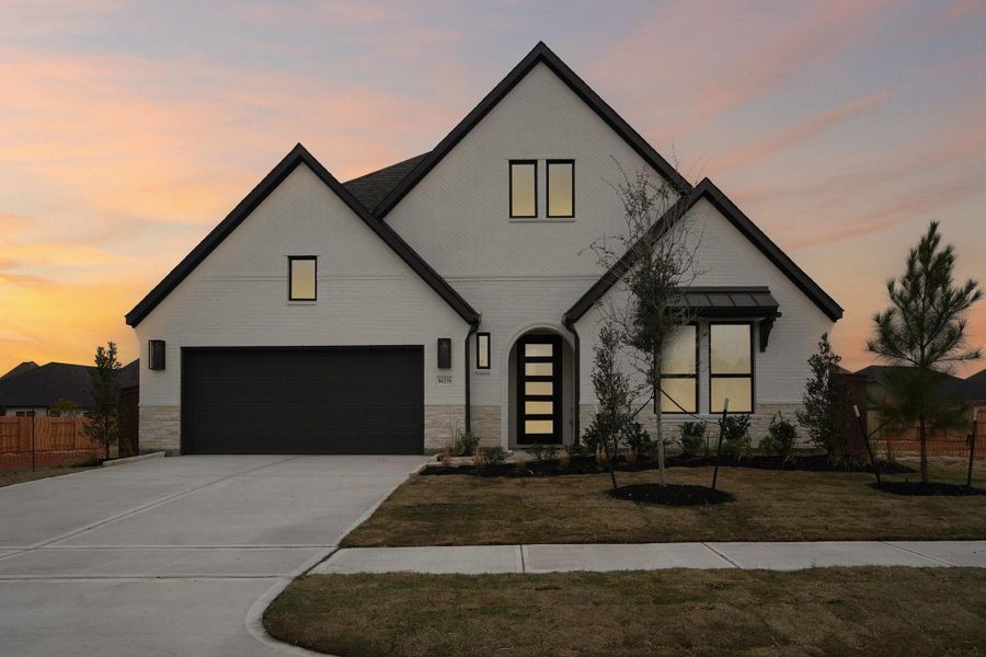 Front exterior of a new home in Evergreen 55', Conroe, TX, highlighting curb appeal (Image 25).