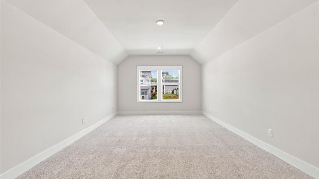 Vibrant carpeted bonus room offering flexibility as a study nook, game room, or second family space at Fox Hollow