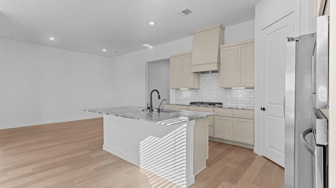 Kitchen adorned with painted cabinets seamlessly integrated into an open dining area layout.