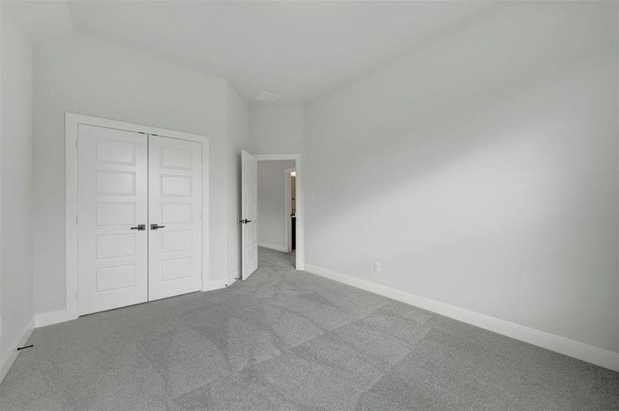 Unfurnished bedroom with carpet floors and a closet