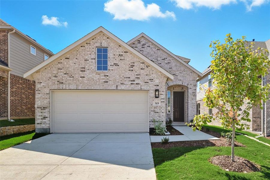 View of front of home featuring driveway, brick siding, an attached garage, and a front yard