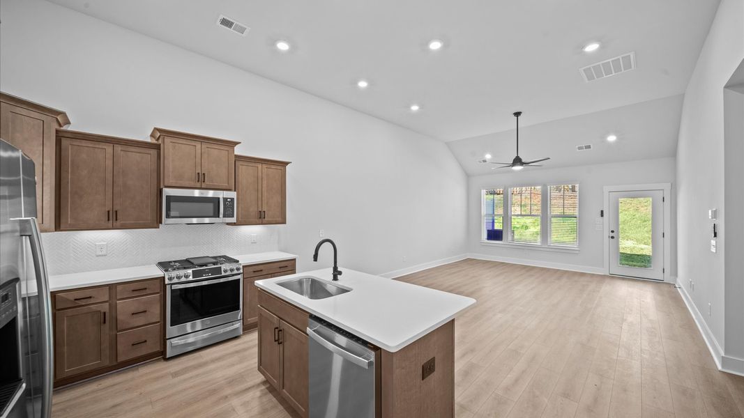 Exceptional family space featuring two-story ceilings, hardwood flooring, and tasteful finishes throughout