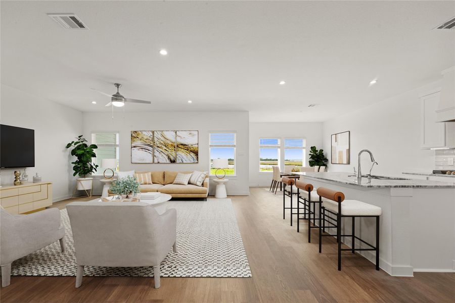 Discover the ultimate in modern living with this expansive, sunlit great room and chef's kitchen. Featuring a generous island with seating, perfect for morning coffee or evening cocktails, and large windows offering great views. *Virtually Staged