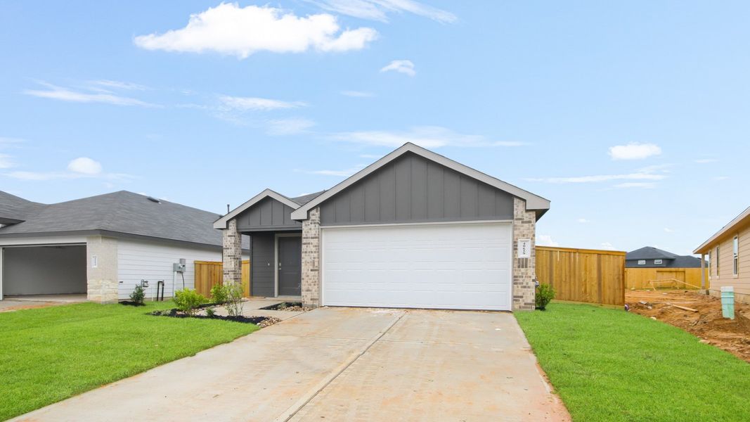 Front exterior of a new home in Mill Creek, Magnolia, TX, highlighting curb appeal (Image 24). Front exterior of a new home in Mill Creek, Magnolia, TX, highlighting curb appeal (Image 24).