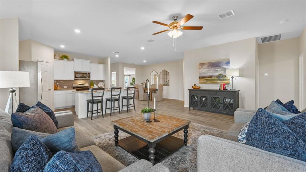 Living area with light wood-style floors, ceiling fan, and recessed lighting Living area with light wood-style floors, ceiling fan, and recessed lighting