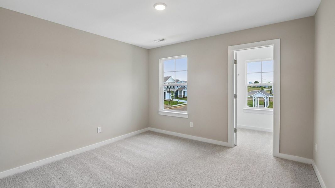Bedroom with walk-in closet and window Bedroom with walk-in closet and window