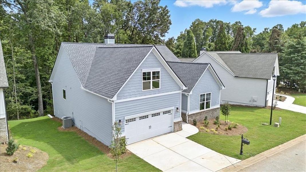 Front exterior of a new home in Traditions of Braselton, Jefferson, GA, highlighting curb appeal (Image 23). Front exterior of a new home in Traditions of Braselton, Jefferson, GA, highlighting curb appeal (Image 23).