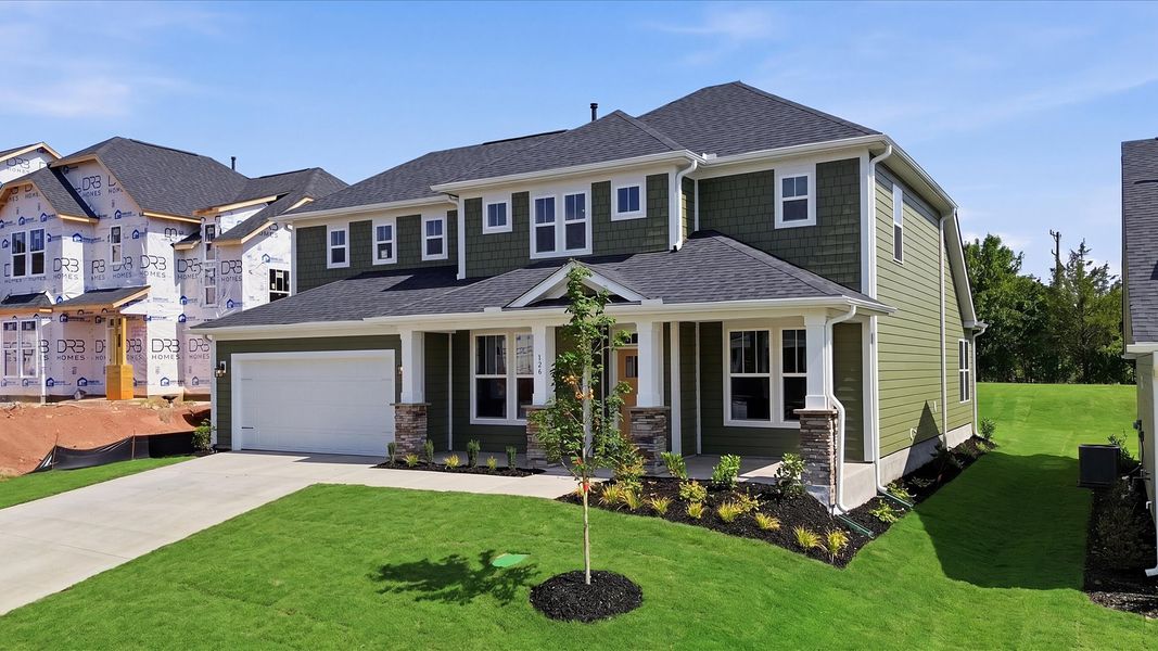 Vibrant home exterior in a thoughtfully planned community near city conveniences by DRB Homes Vibrant home exterior in a thoughtfully planned community near city conveniences by DRB Homes