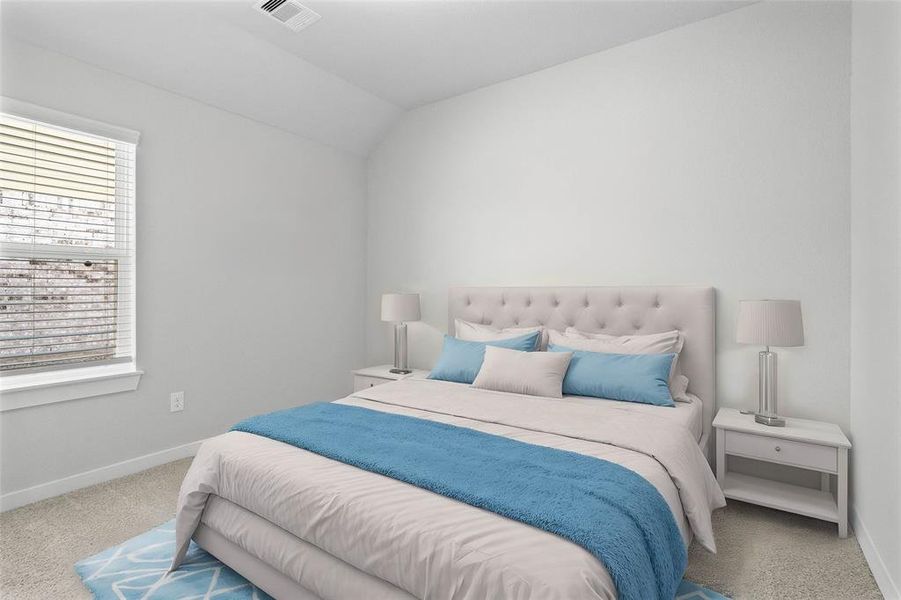 Secondary bedroom features plush carpet, custom paint, lighting, and a large windows with privacy blinds.