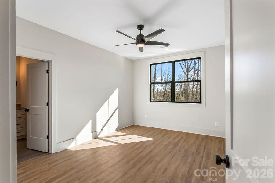 This guest bedroom upstairs has a private ensuite bath and walk in closet.