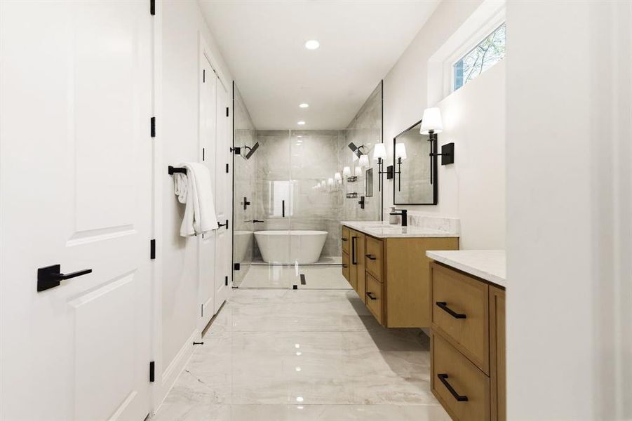 Bathroom featuring a stall shower, vanity, recessed lighting, light marble finish floors, and a soaking tub