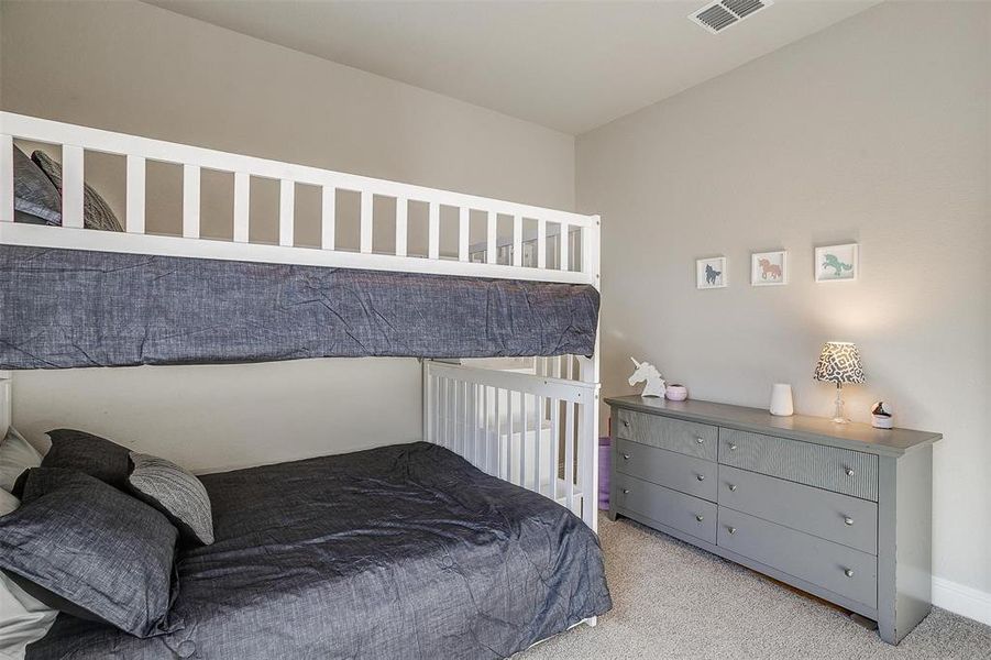 Bedroom featuring light carpet