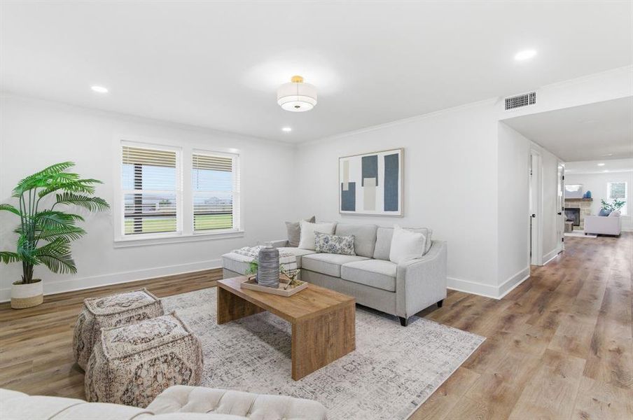 The living area features light-colored flooring, white walls, and recessed lighting The living area features light-colored flooring, white walls, and recessed lighting