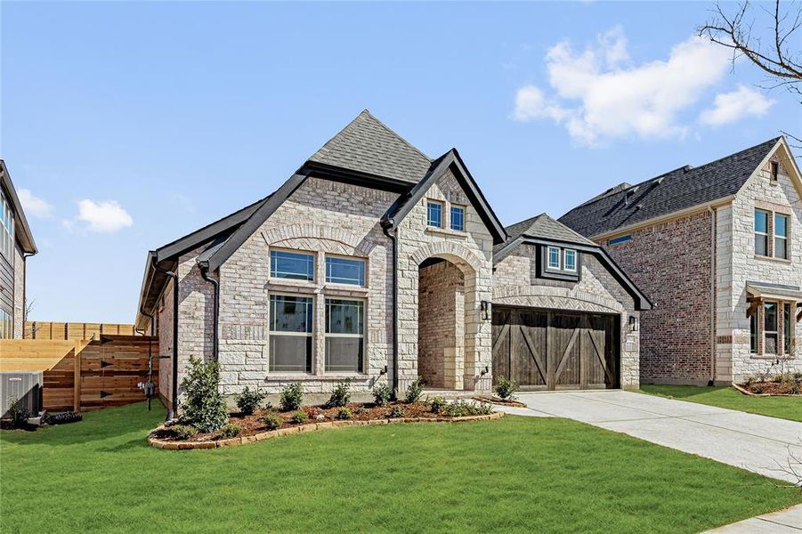 Front exterior of a new home in Painted Tree Woodland District 50, McKinney, TX, highlighting curb appeal (Image 25).