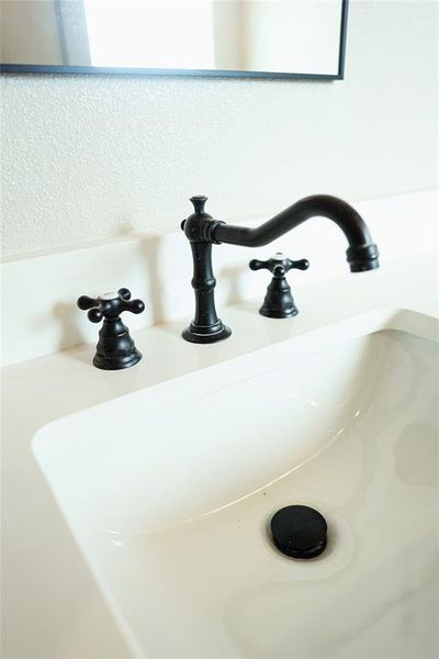 Integrated white rectangular sink with a matte black faucet and drain