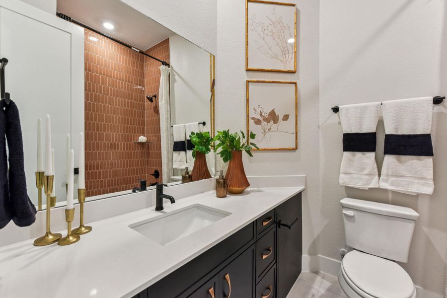 Bathroom featuring a shower with curtain and vanity