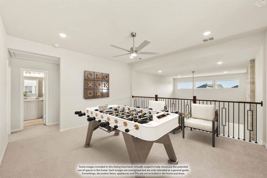 Upstairs game room with foosball table, ceiling fan, and open railing overlooking lower level