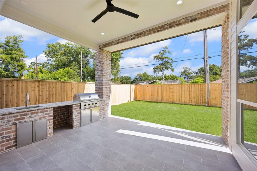 Fire up the grill and enjoy outdoor living in style on this 17 x 13 covered patio with a built-in Coyote gas grill, ceiling fan and plenty of room to dine, relax and entertain while overlooking the fenced backyard.
