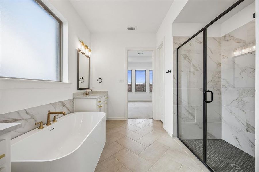 Your new owner's bath features a free standing tub and spacious walk in shower.