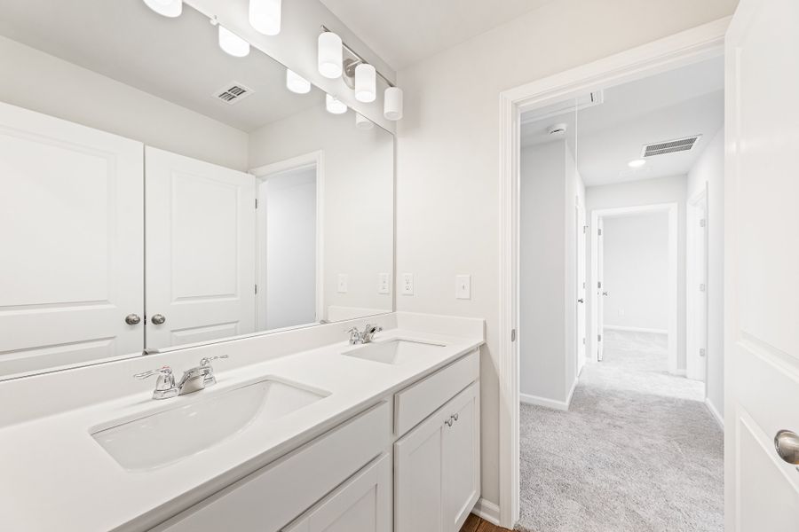 A bathroom with white cabinets. A bathroom with white cabinets.