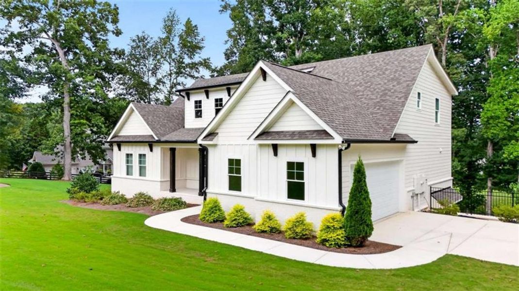 Front exterior of a new home in , Hoschton, GA, highlighting curb appeal (Image 28).