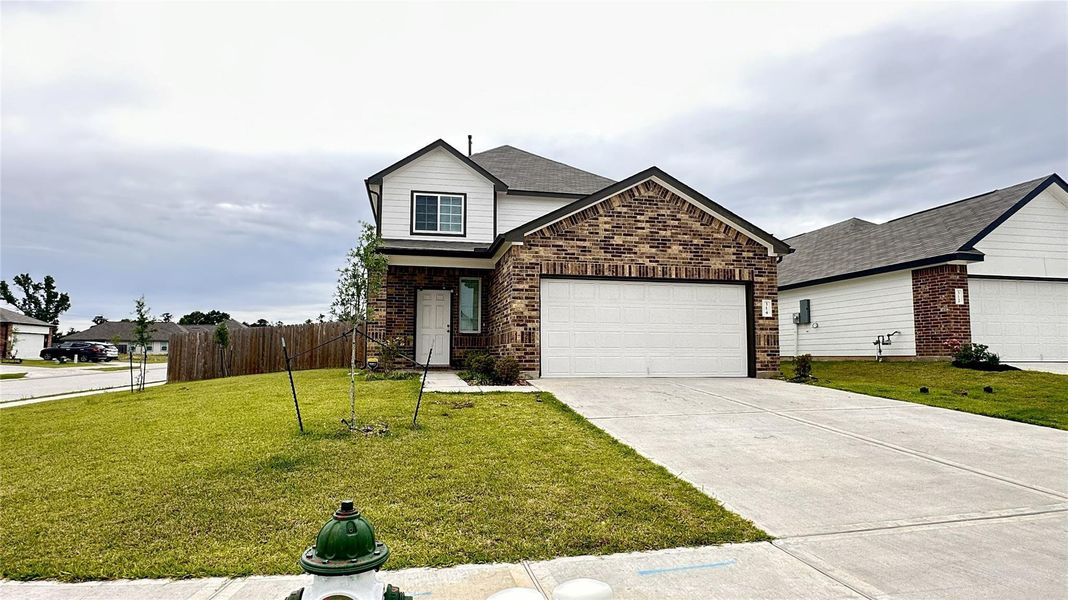 Front exterior of a new home in Hunter's Creek, Huntsville, TX, highlighting curb appeal (Image 17).