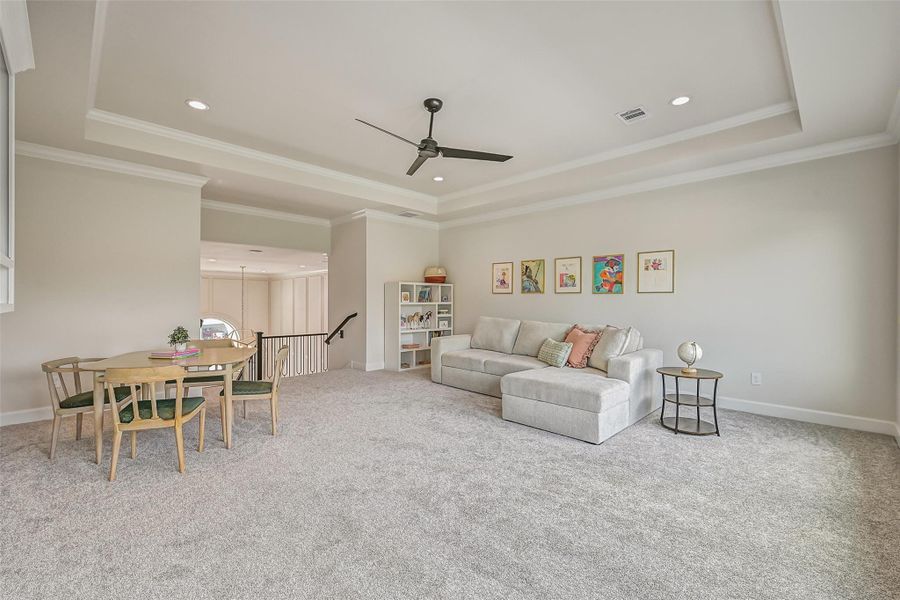 An expansive upstairs gameroom provides plenty of space for multiple seating, game & entertainment areas, featuring plush carpet, a dramatic tray ceiling with crown molding and an open overlook to the 20' foyer below.