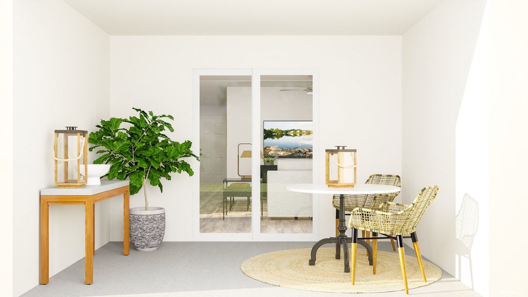 A room with a table chairs and a plant in it.