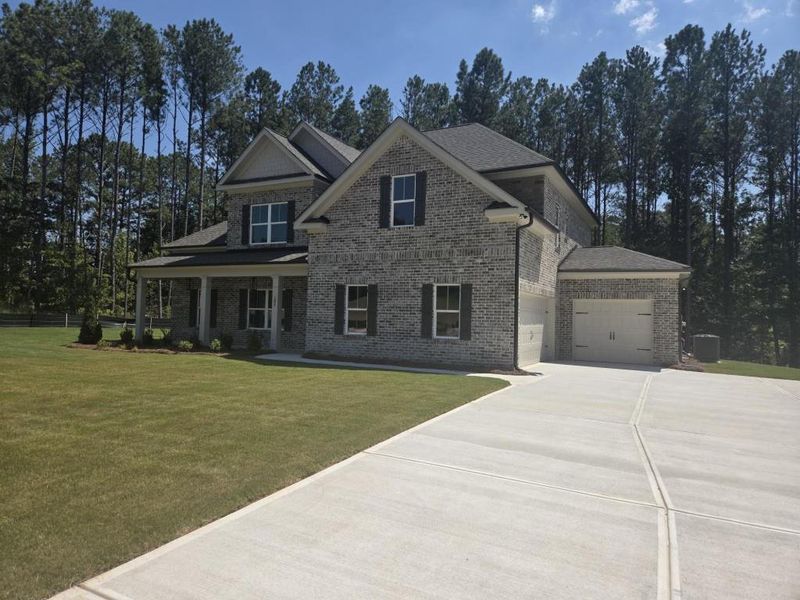 Front exterior of a new home in Palm Springs Manor Create Homes, Ellenwood, GA, highlighting curb appeal (Image 12). Front exterior of a new home in Palm Springs Manor Create Homes, Ellenwood, GA, highlighting curb appeal (Image 12).