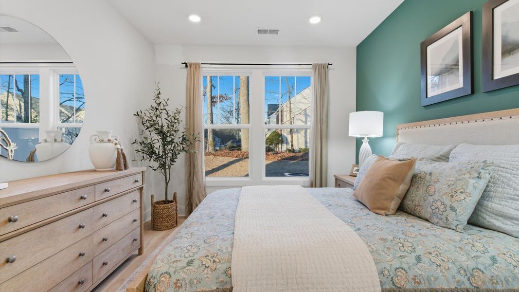 Serene and stylish primary bedroom featuring hardwood flooring and a thoughtful, modern layout in Greenville, SC