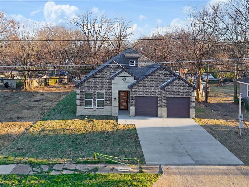View of front facade with brick siding, driveway, and an attached garage View of front facade with brick siding, driveway, and an attached garage
