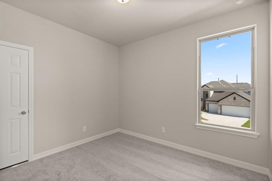 Your secondary bedroom features plush carpet, fresh paint, closet, and a large window that lets in plenty of natural lighting.