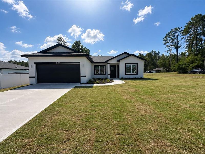 Front exterior of a new home in , Ocala, FL, highlighting curb appeal (Image 1). Front exterior of a new home in , Ocala, FL, highlighting curb appeal (Image 1).