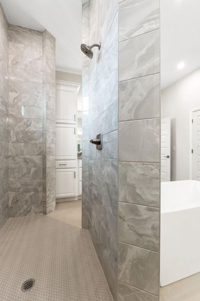 Full bath featuring a walk in shower and a soaking tub