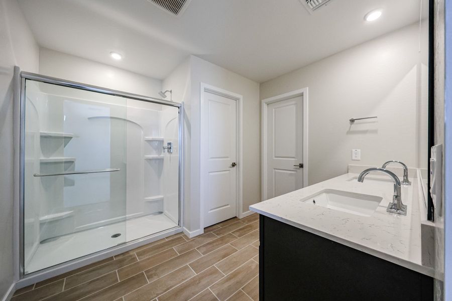 A bathroom with a glass shower. A bathroom with a glass shower.