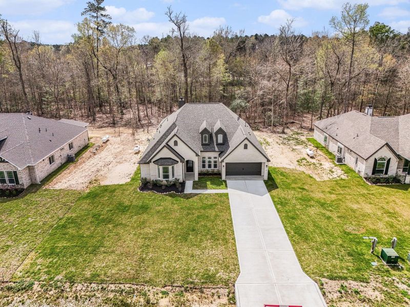 Front exterior of a new home in Encino Estates, Dayton, TX, highlighting curb appeal (Image 19).