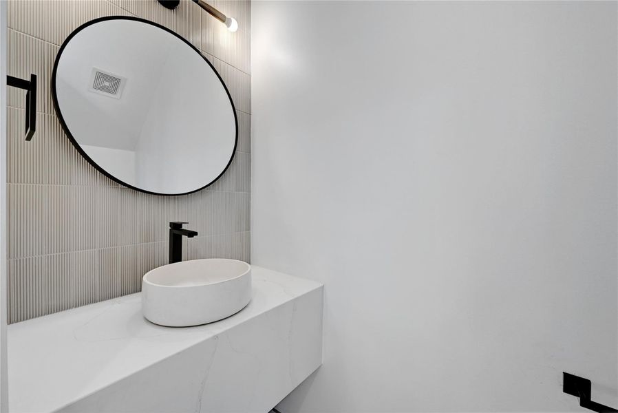 Bathroom with visible vents and a sink