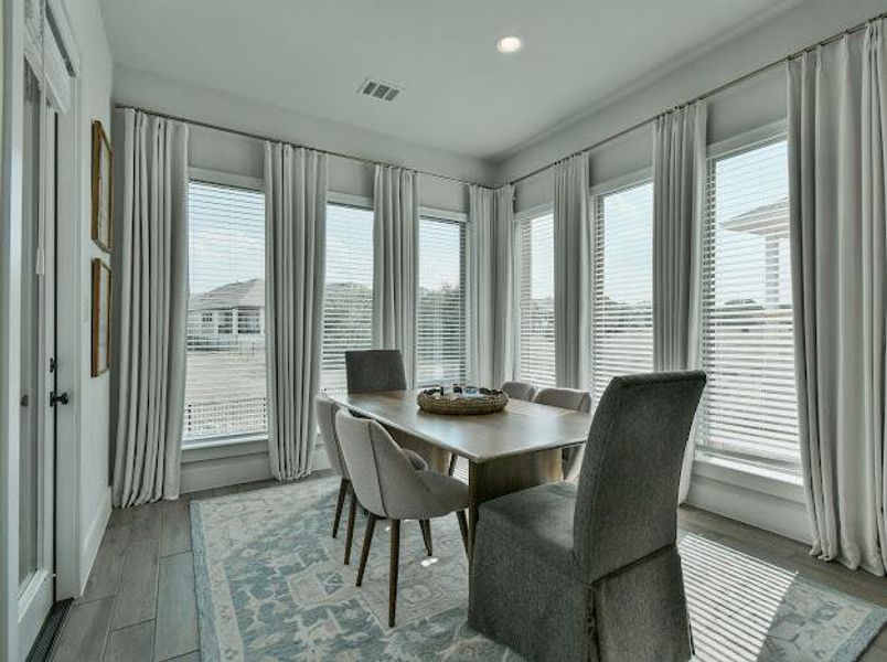 Dining area with wood finished floors and recessed lighting Dining area with wood finished floors and recessed lighting