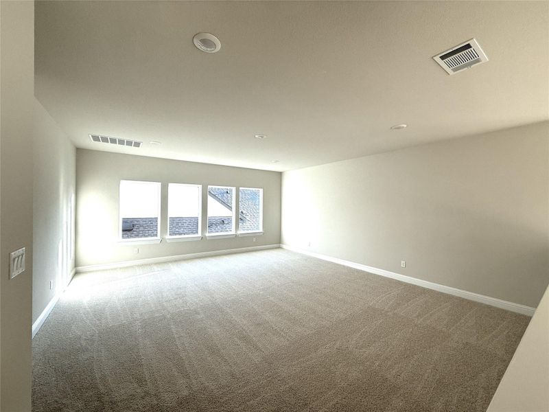 Carpeted empty room featuring baseboards