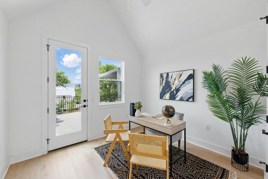 Office space with vaulted ceiling, light wood-type flooring, and ceiling fan Office space with vaulted ceiling, light wood-type flooring, and ceiling fan