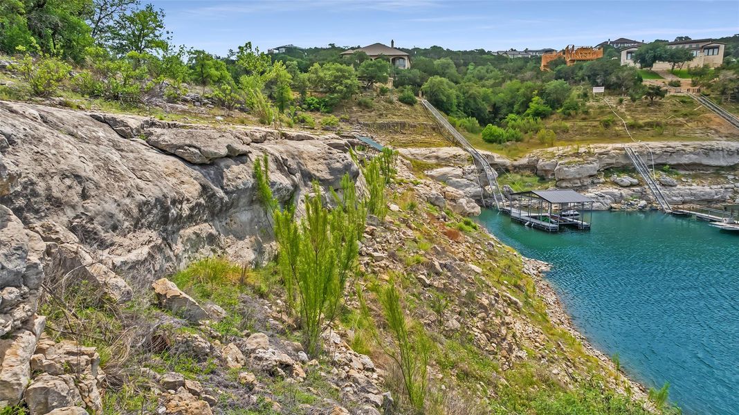 The topography is a striking mix of gently sloping build sites and dramatic limestone cliffs.