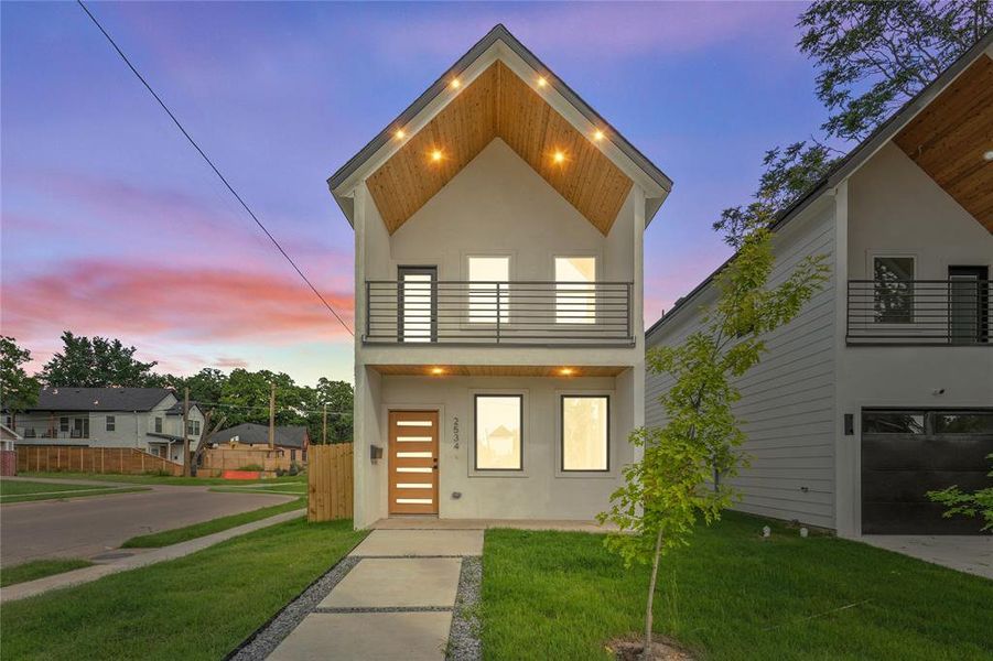 Contemporary home featuring a balcony and stucco siding Contemporary home featuring a balcony and stucco siding