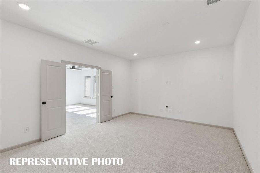 The grand media room adjacent to the light filled game room create the ultimate family entertainment area.  REPRESENTATIVE PHOTO