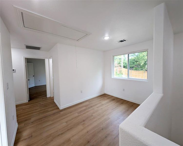 Unfurnished room featuring hardwood / wood-style flooring