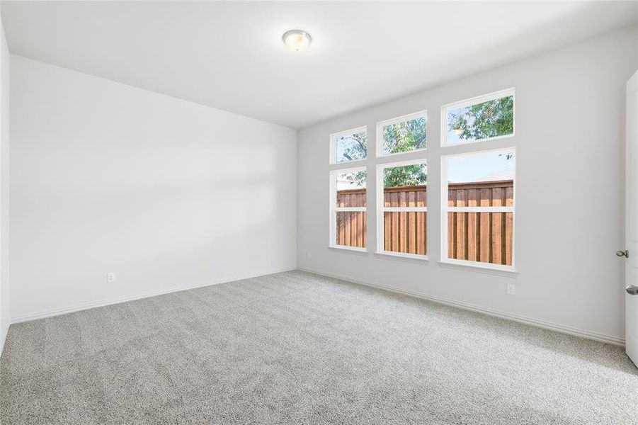 Spare room with carpet and baseboards