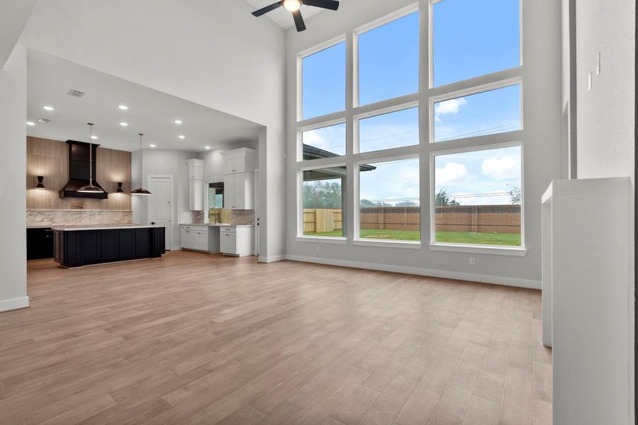 The open layout is made warm and inviting by dark cabinets and accent walls.