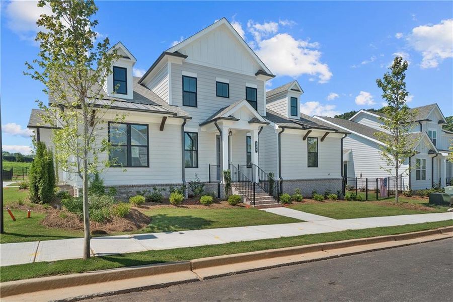 Front exterior of a new home in Promenade at Sawnee Village, Cumming, GA, highlighting curb appeal (Image 24).